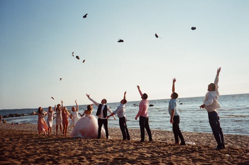 People Throwing Things Near the Seashore