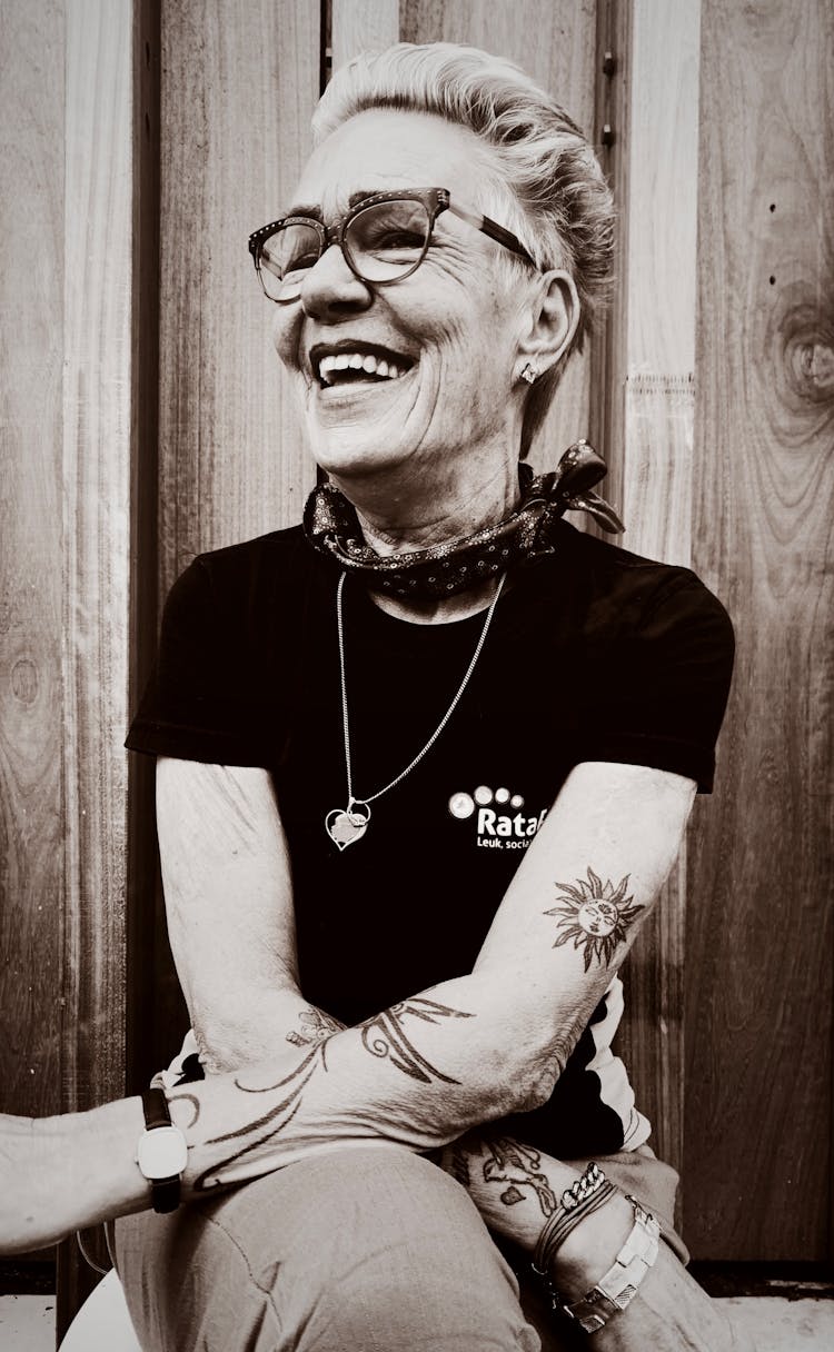 Smiling Woman With Tattoos Sitting