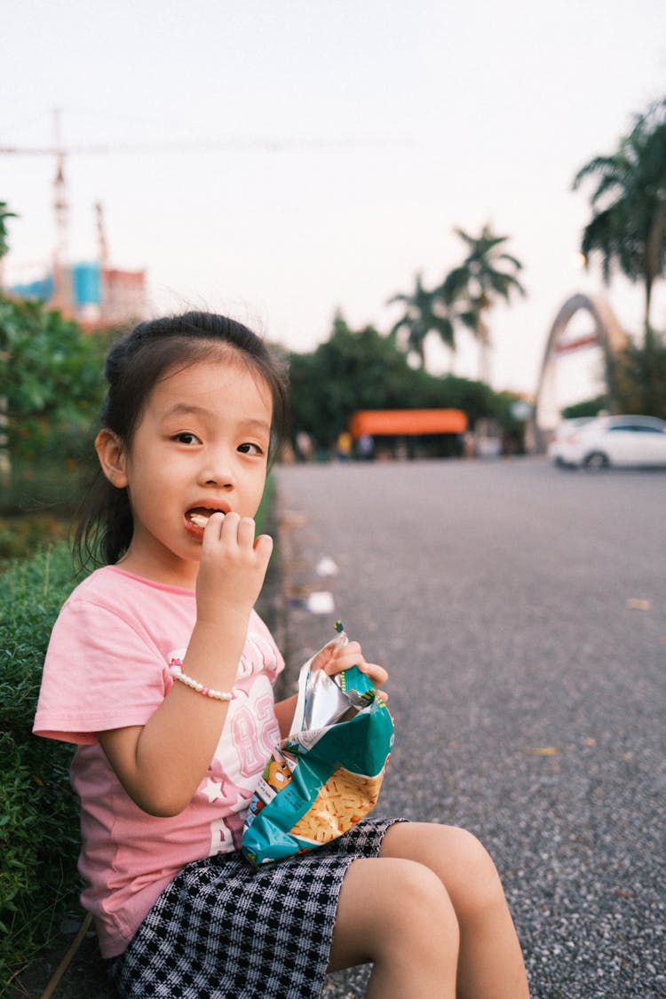 Photo Of A Child Eating Chips