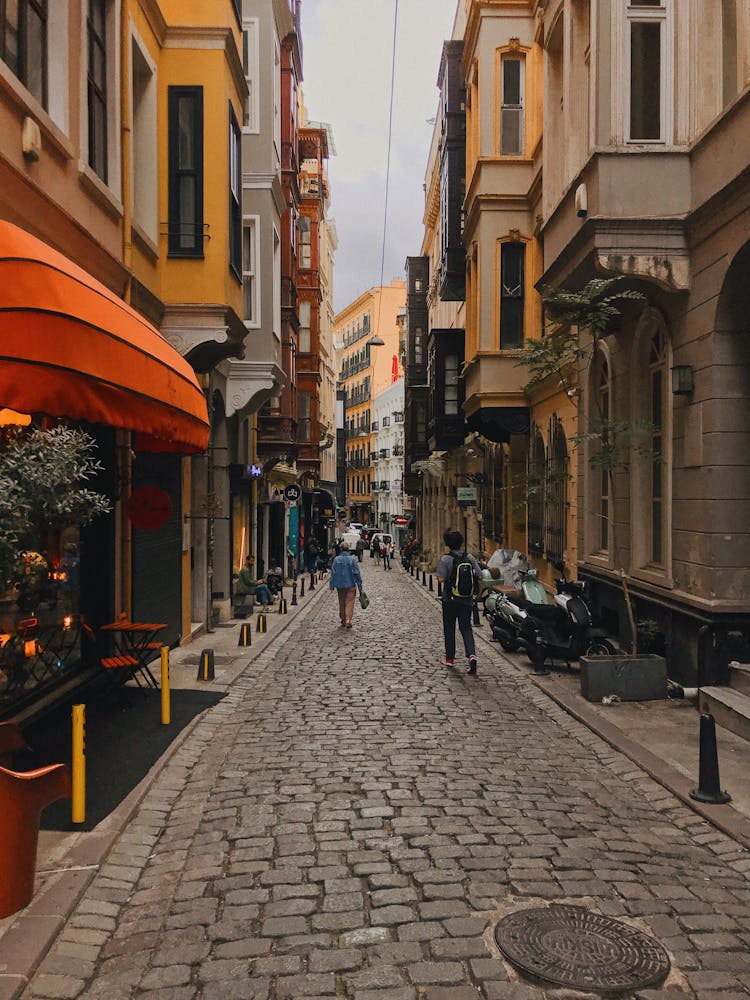 People Walking On Sidewalk Near Buildings