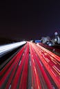 Time Lapse Photography of Fast Moving Cars on the Road during Night Time