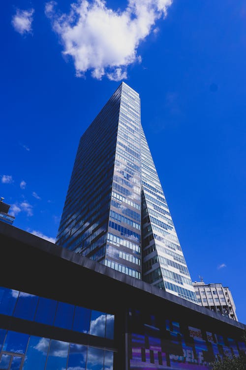 Low Angle Photography of High Rise Glass Building Under Blue Sky