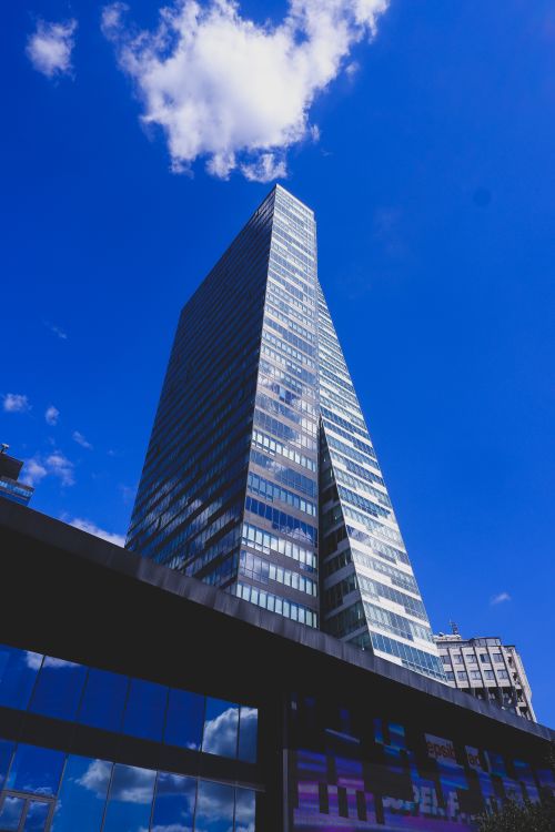 Free A low angle view of a modern skyscraper reaching into the clear blue sky in Istanbul, Turkey. Stock Photo