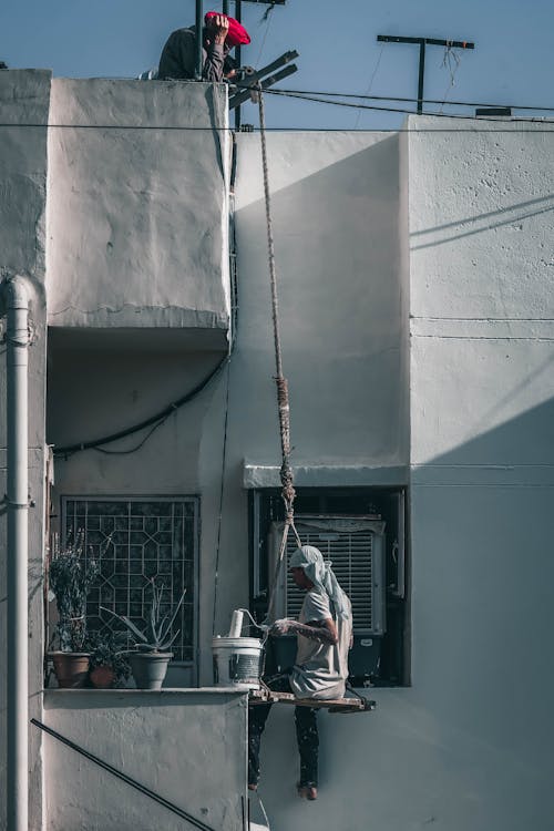 Man Painting a House