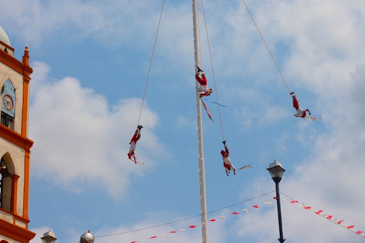 People Hanging On Bungee Ropes