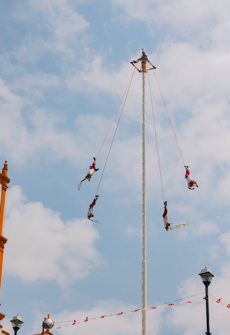 People Flying On Ropes On Traditional Festival