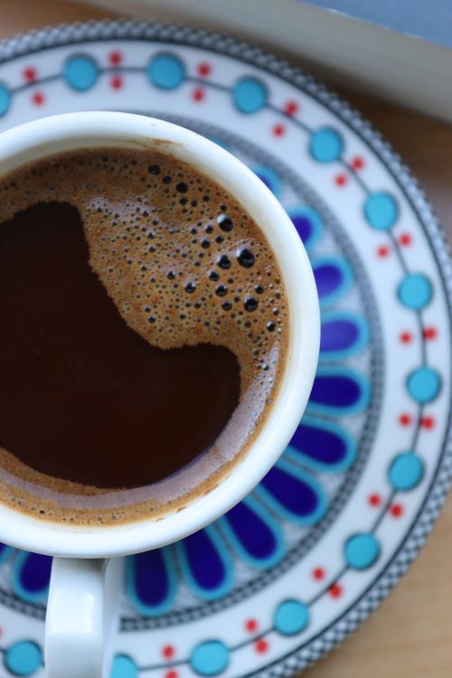 Free Top view of a hot coffee in a ceramic mug with decorative saucer. Stock Photo