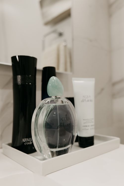Free Sophisticated selection of luxury perfumes and body care products on a white tray. Stock Photo