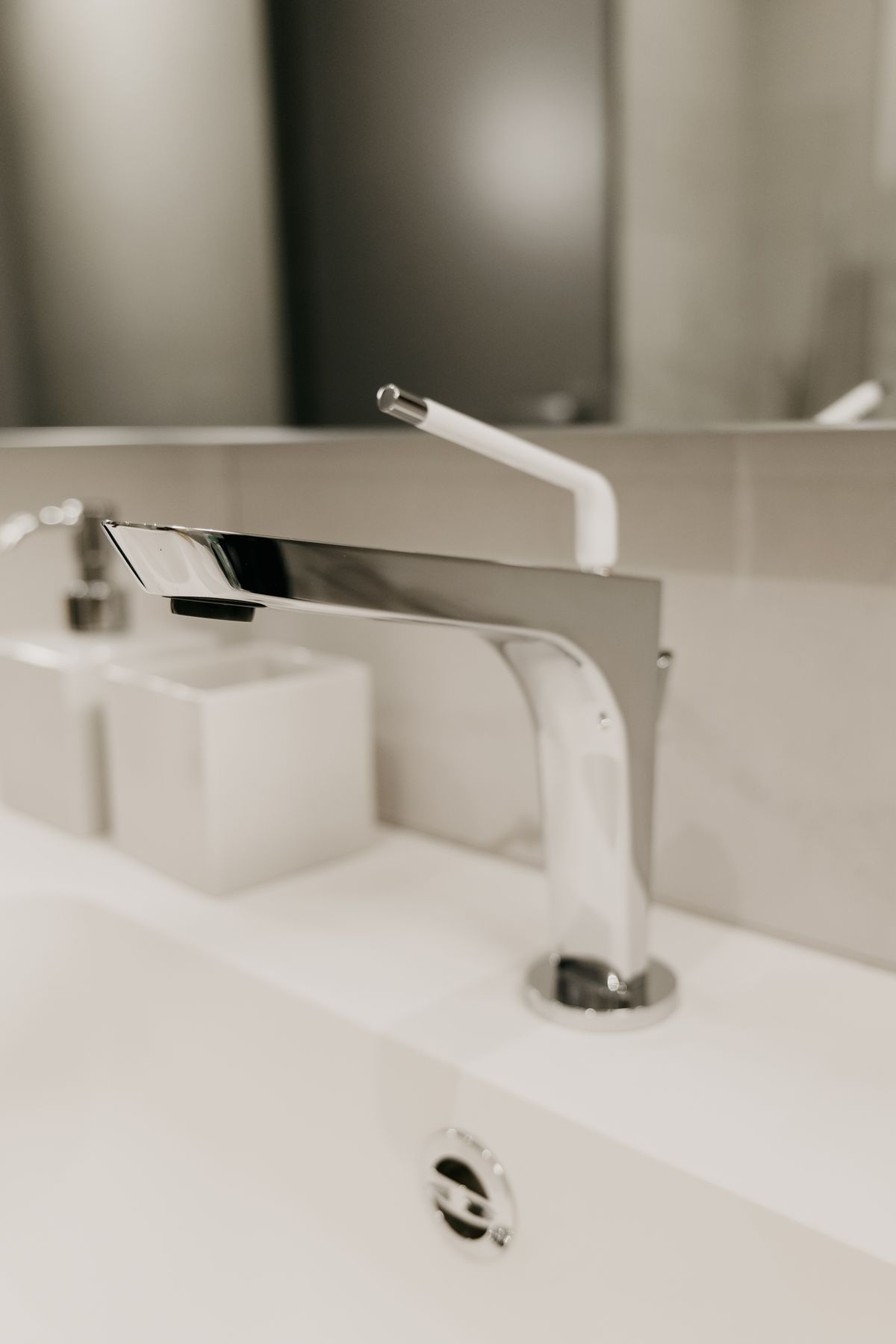 Chrome basin mixer tap on a white ceramic wash basin