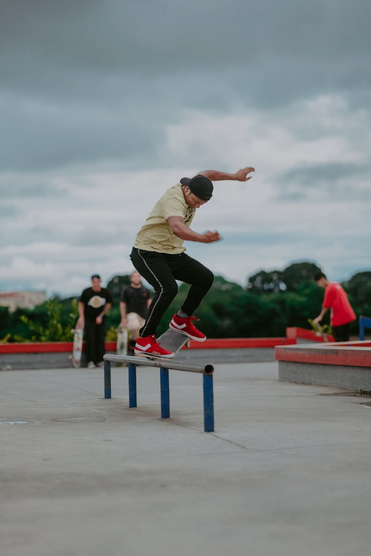 A Man Skateboarding In A Skate Park