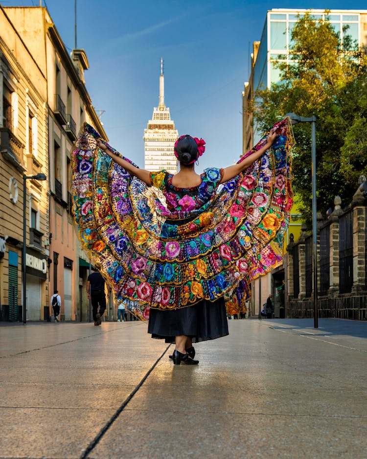 Woman In Traditional Dress Dancing On The Street