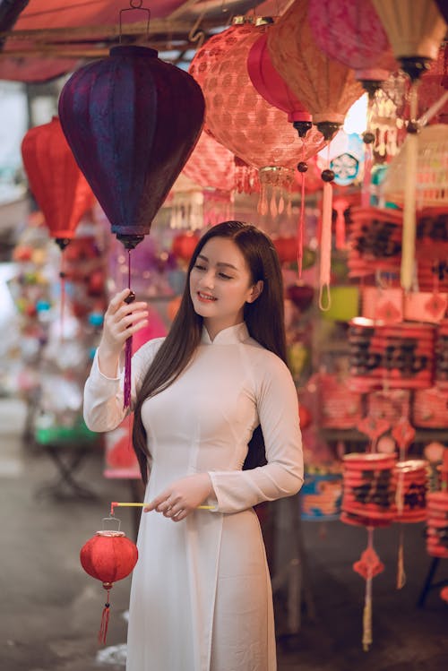 Woman Holding Paper Lantern Beside Store