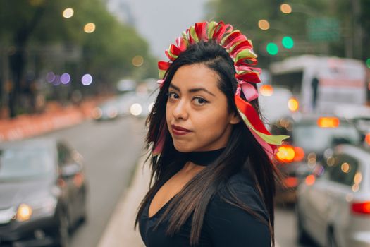  Mexican girl, young and beautiful with a hairstyle that simulates Michoacán dolls or also known as Amealco dolls on Reforma Street in Mexico City.