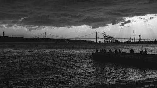 Grayscale Photo of Bridge over Body of Water