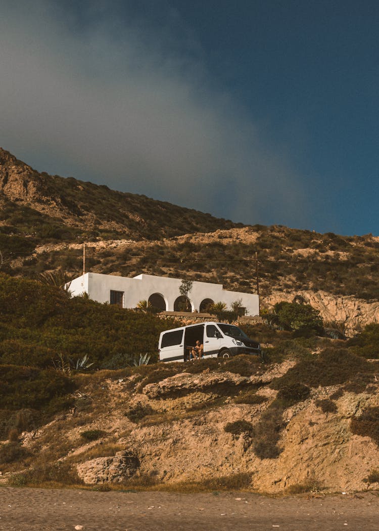 Residential House And A Van On A Hill In A Desert 