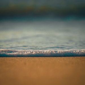 Seafoam on sand photo by Edwin Guzman on Pexels