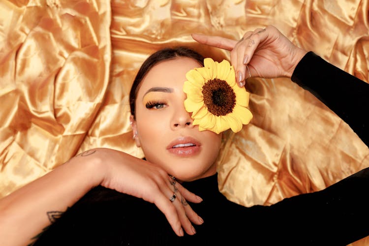 A Woman Lying On Yellow Textile