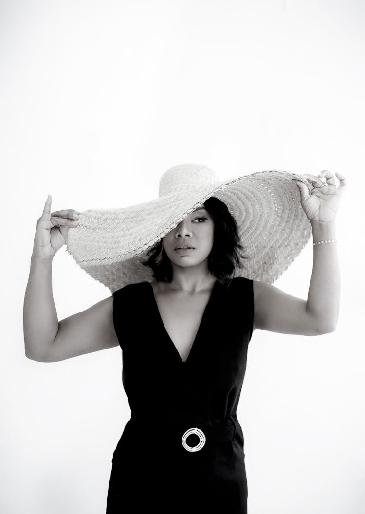 Woman Wearing A Big Round Straw Hat 