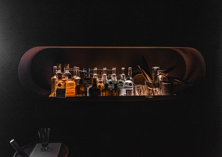 Alcohol Bottles In Bar In Dark