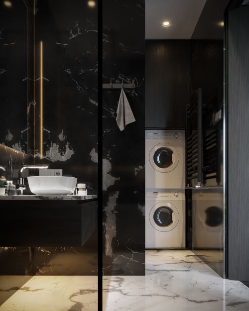 Free Sleek modern bathroom with marble tiles, luxury fixtures, and stacked washing machines. Stock Photo
