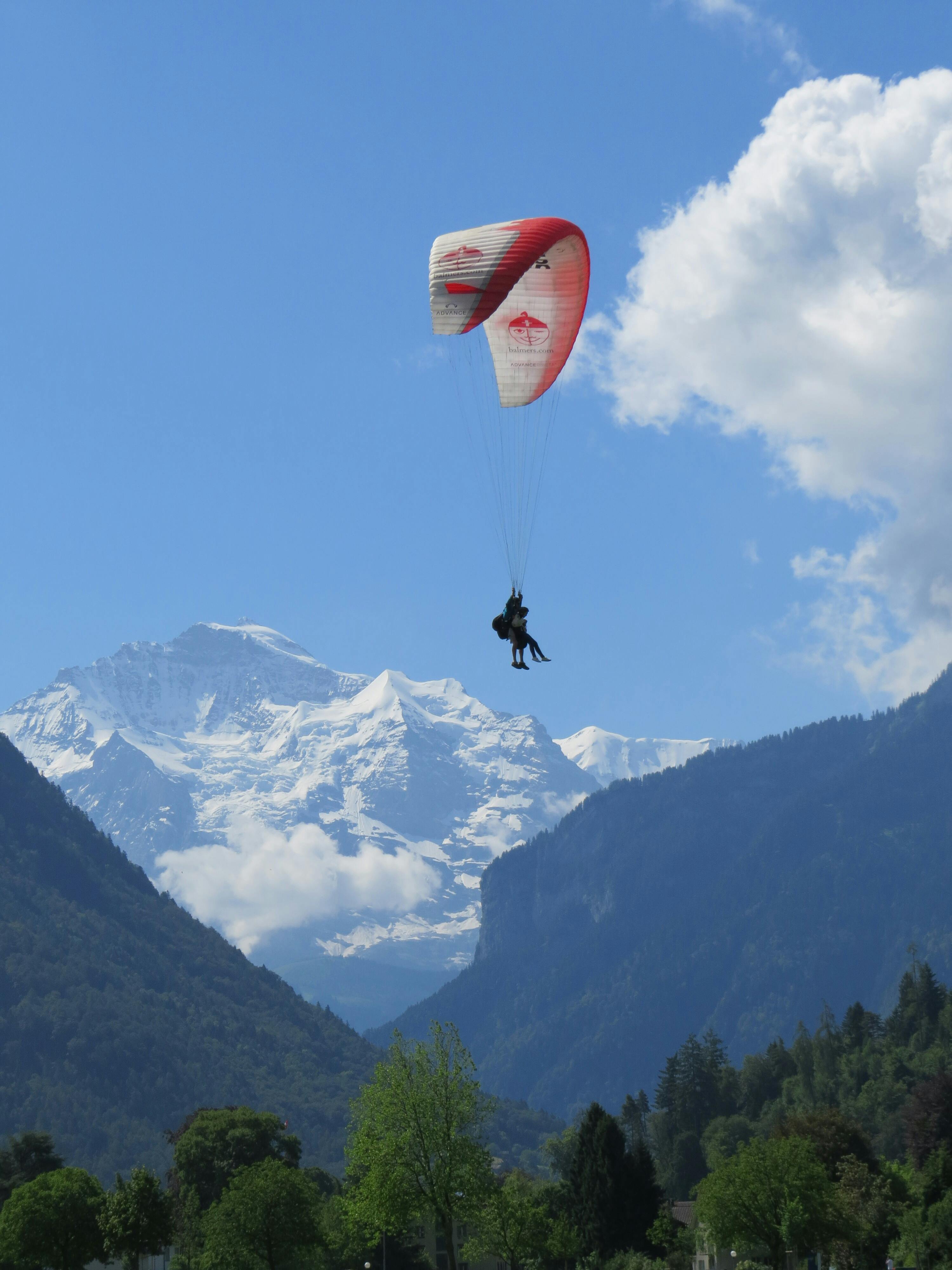 A Person Paragliding at Sunset · Free Stock Photo