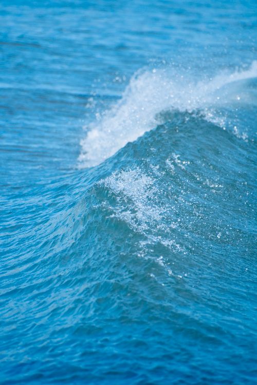 Free Close-up shot of a crashing ocean wave at Westerly Beach, capturing the motion and vibrant blue tones. Stock Photo