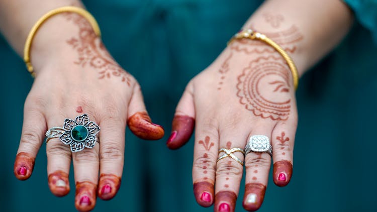 A Person's Hands With Henna Tattoos