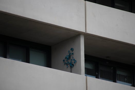 Stylish modern apartment exterior with minimal balcony decoration and concrete design.