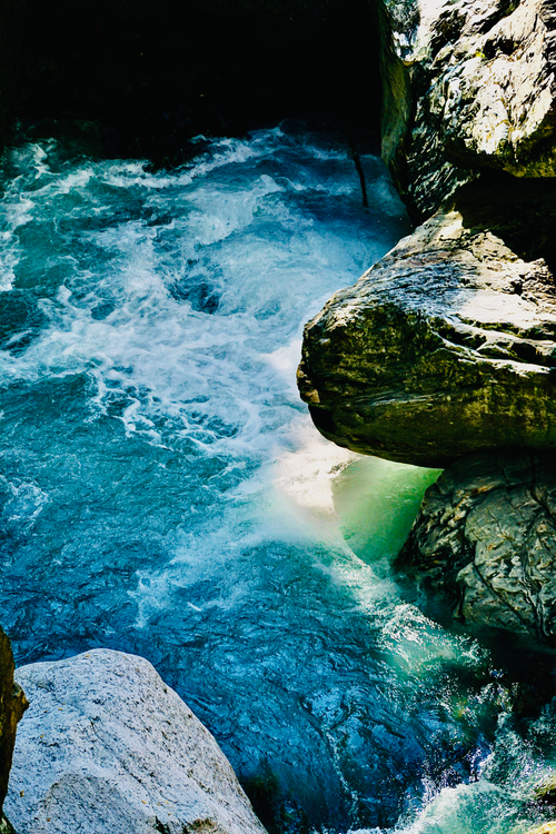 Free A mesmerizing view of a waterfall gushing through a rocky gorge, showcasing nature's power. Stock Photo