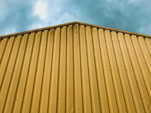 Corrugated Yellow Wall of a Building