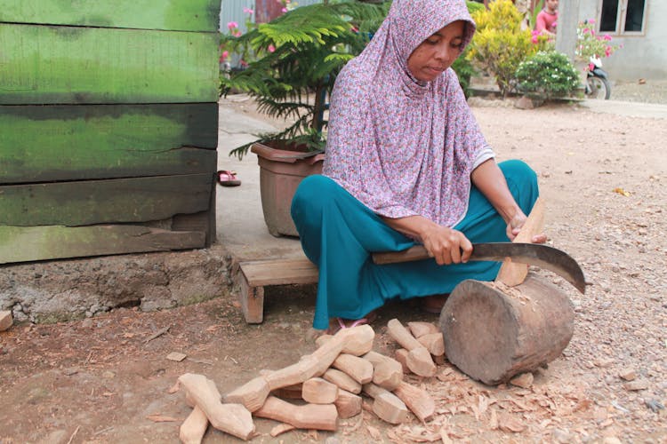 A Woman Cutting Wood