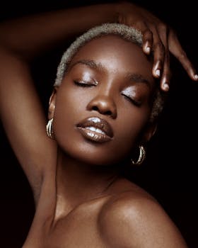 Striking photo of a woman modeling with elegance and grace, eyes closed, in a studio setting.