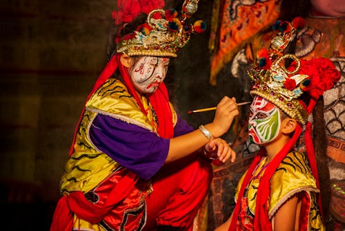 Traditional Theatre Performers Applying Makeup 