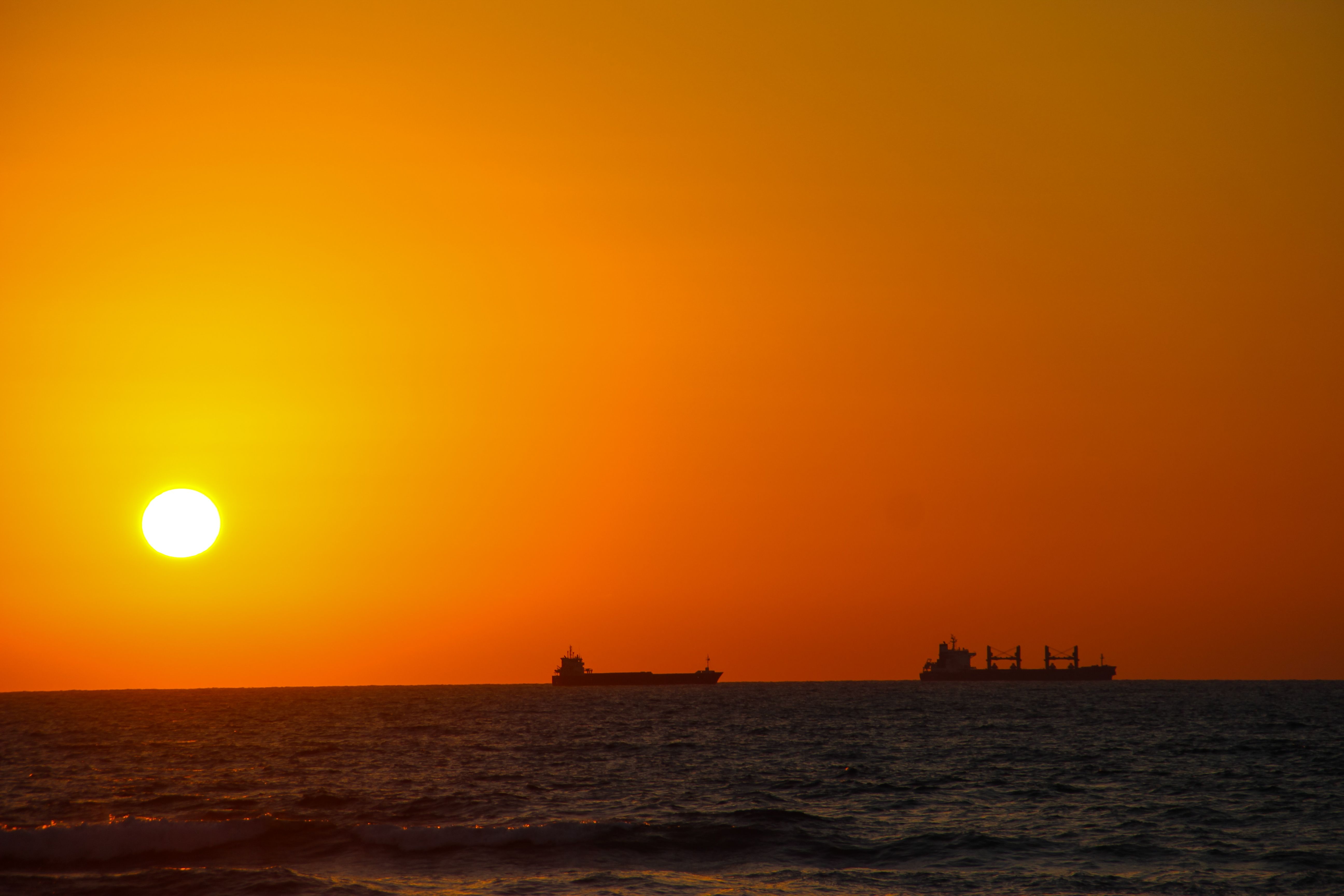Silhouettes of Ships at Sea During Sunset · Free Stock Photo
