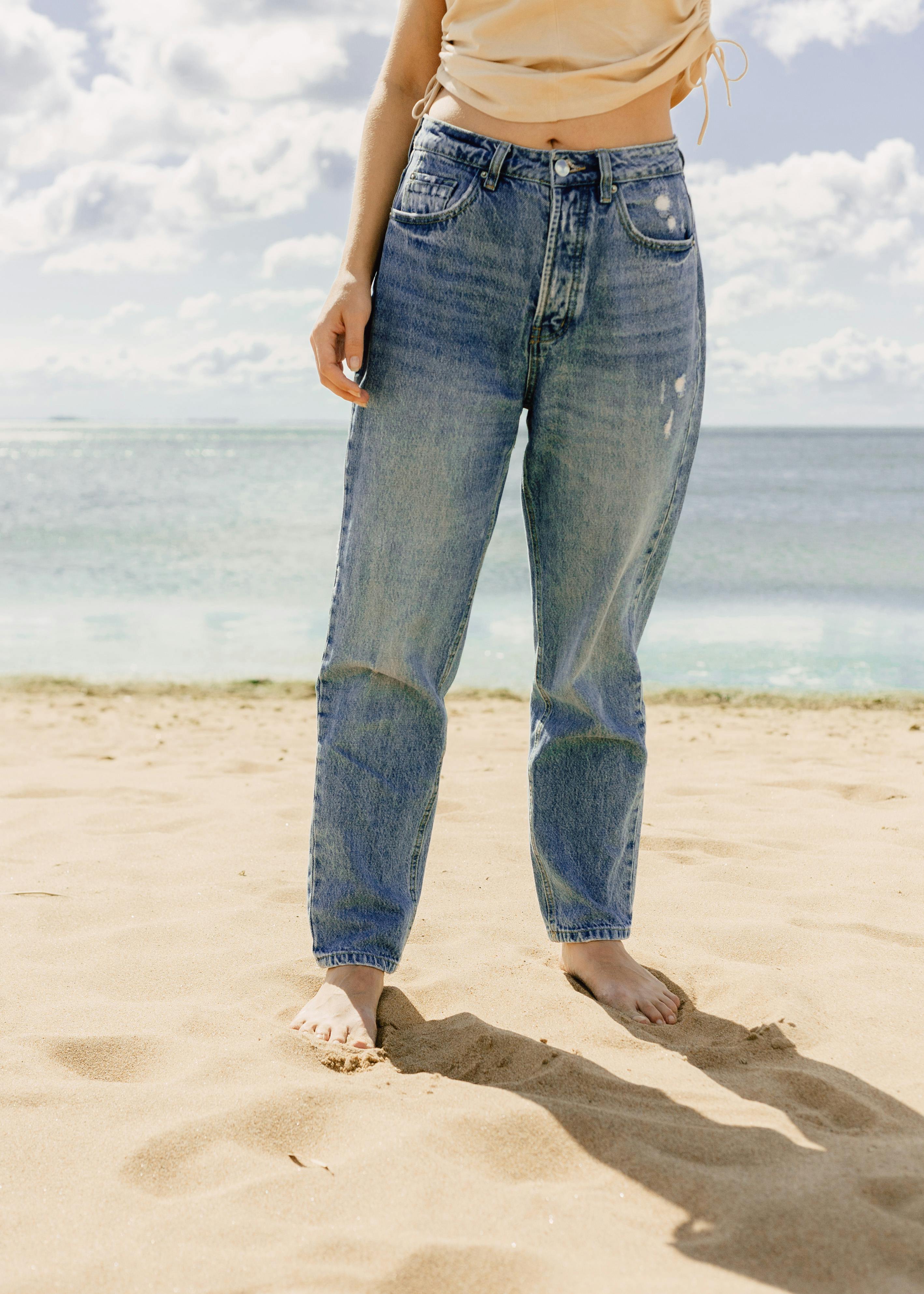 photo of a person s feet on the sand