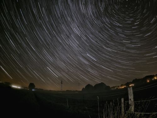 Free Long exposure of star trails over a rural landscape in Oldenburg, Germany. Stock Photo