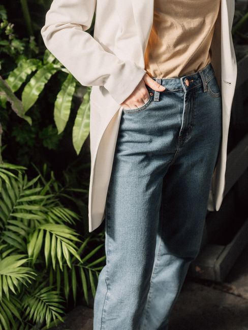 Stylish outfit combining denim jeans and a blazer, ideal for casual or professional settings.