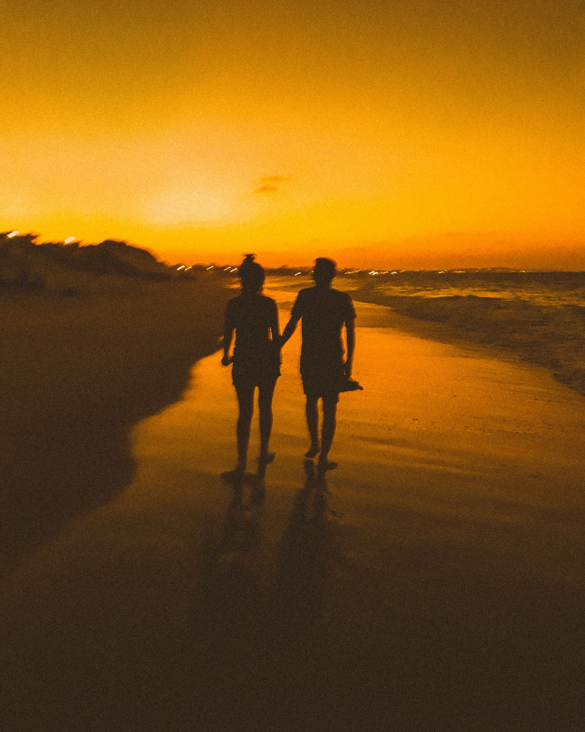 A couple walking the beach at sunset, Baja