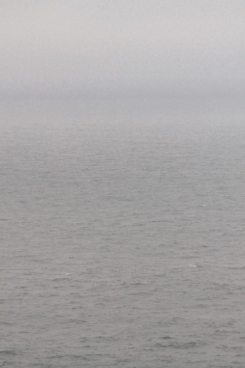 Free A tranquil seascape with calm waters and an overcast sky, creating a peaceful and minimalist scene. Stock Photo
