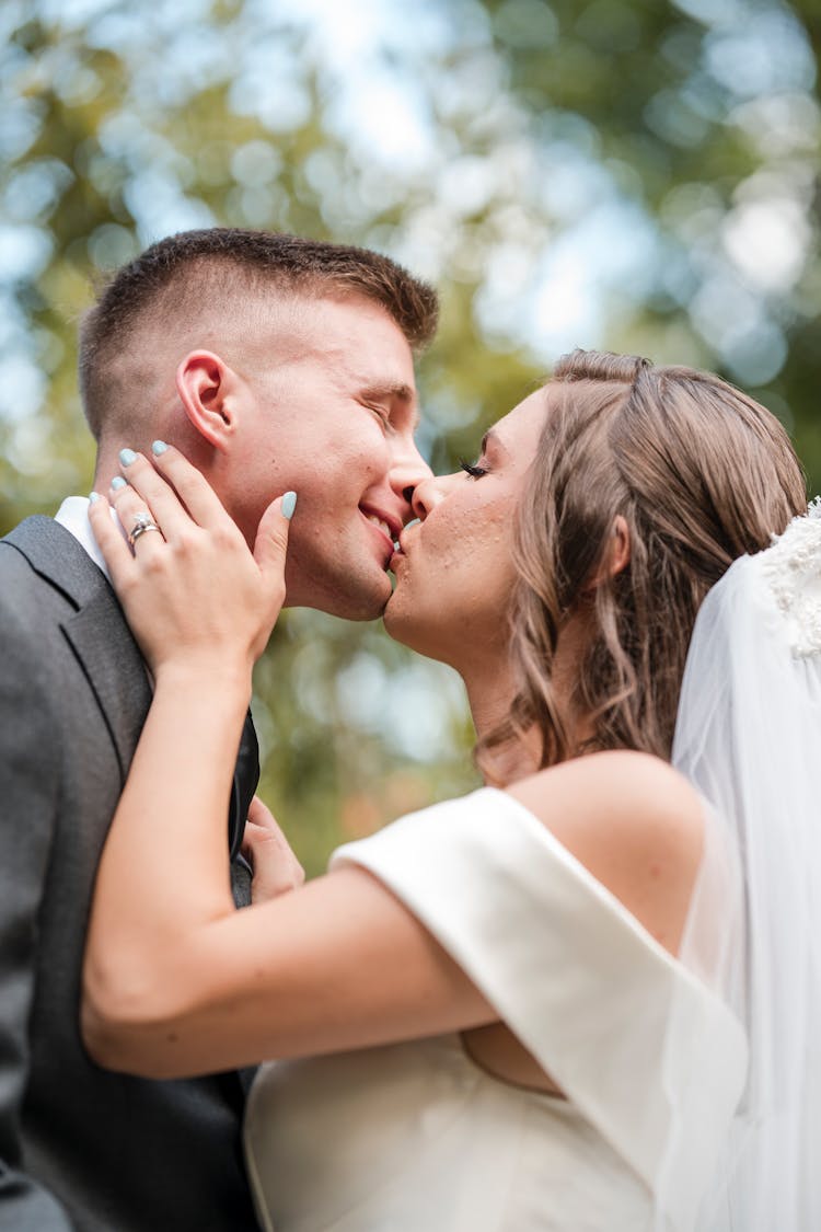 A Groom And A Bride Kissing