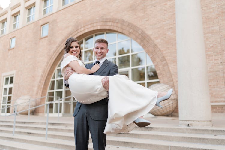 Photo Of A Groom Carrying A Bride