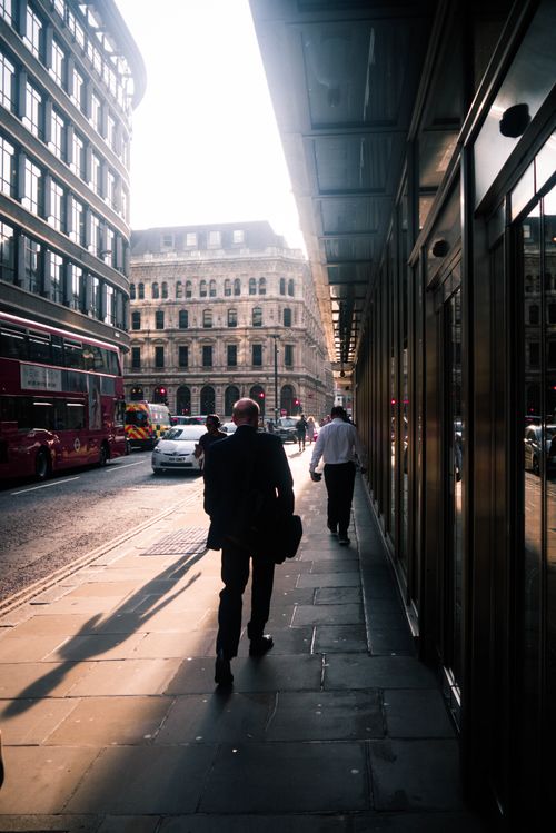 Free A bustling London street scene with people walking and a classic double-decker bus. Stock Photo