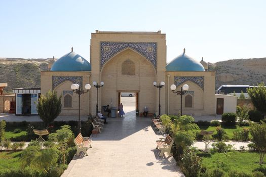 A traditional mosque with blue domes and a serene courtyard, capturing Islamic architecture.