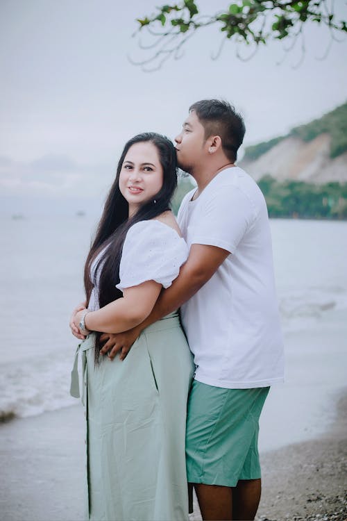 Free A Man in a White Shirt Hugging a Woman Stock Photo