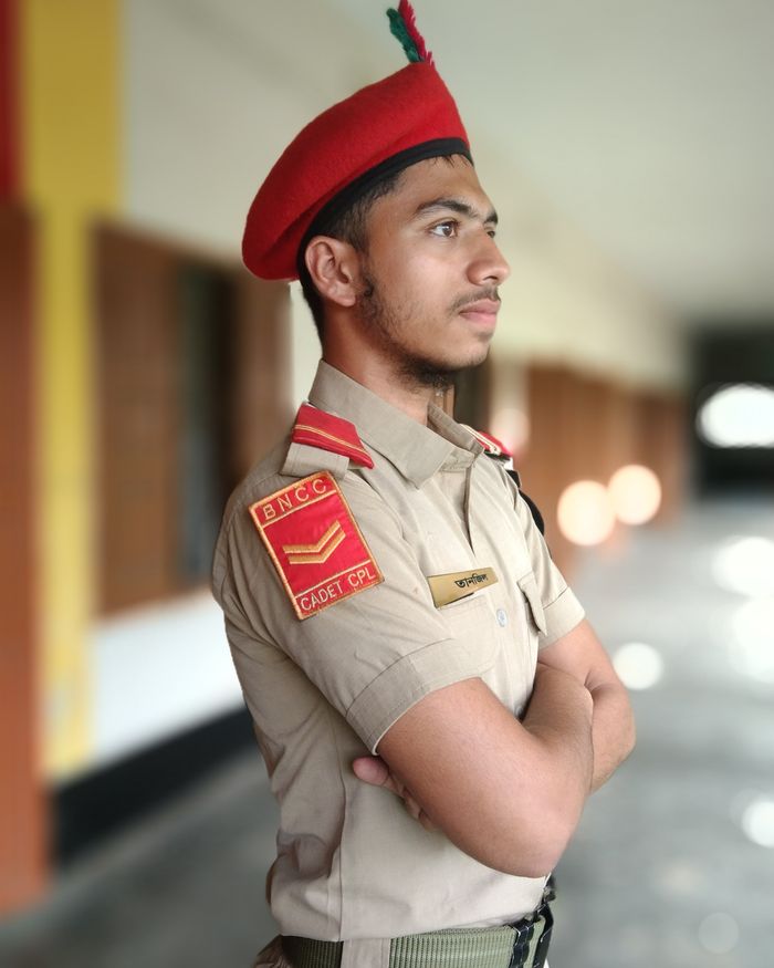 A cadet in uniform posing indoors