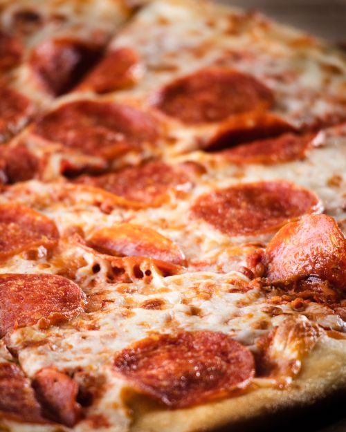 Free Mouthwatering pepperoni pizza with melting cheese and crispy crust, perfect for food lovers. Stock Photo