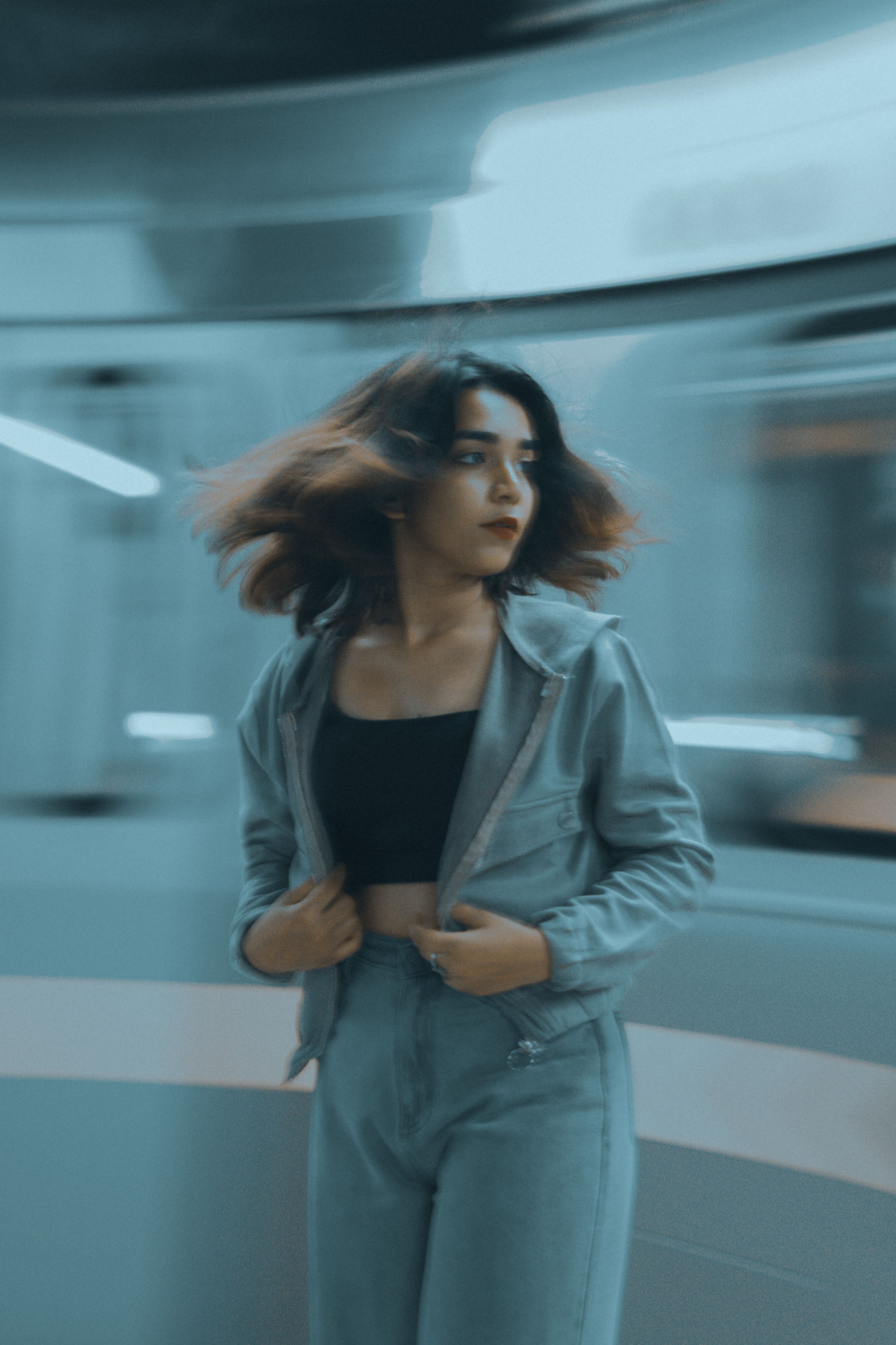 A Woman in Blue Jacket and Denim Jeans · Free Stock Photo