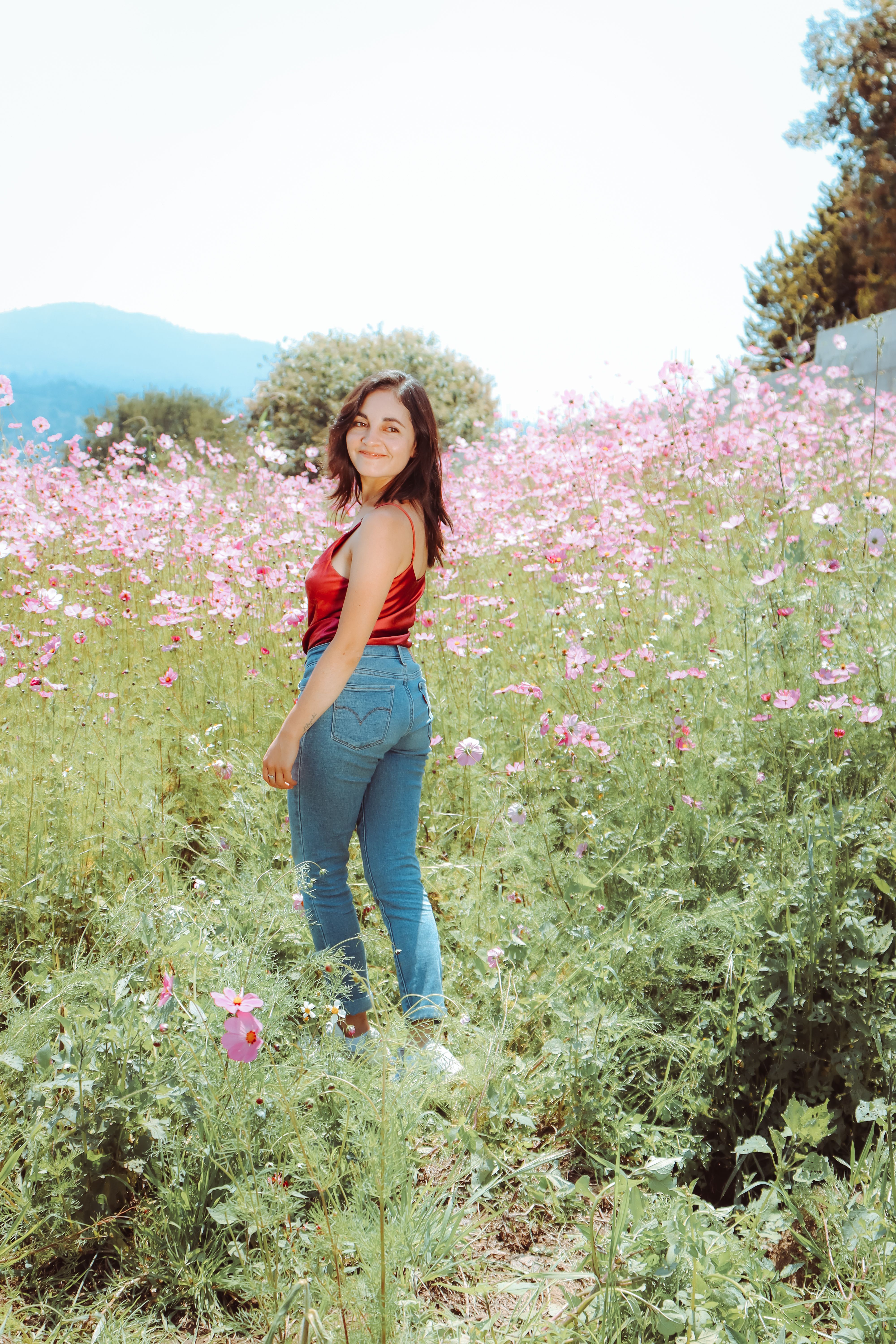 A Woman in Red Tank Top and Blue Denim Jeans · Free Stock Photo