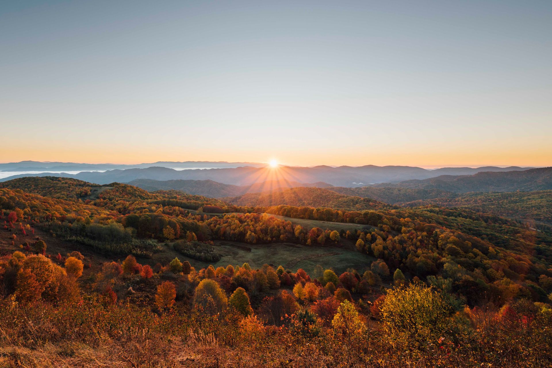 Sunrise over layered forested Appalachian ridges