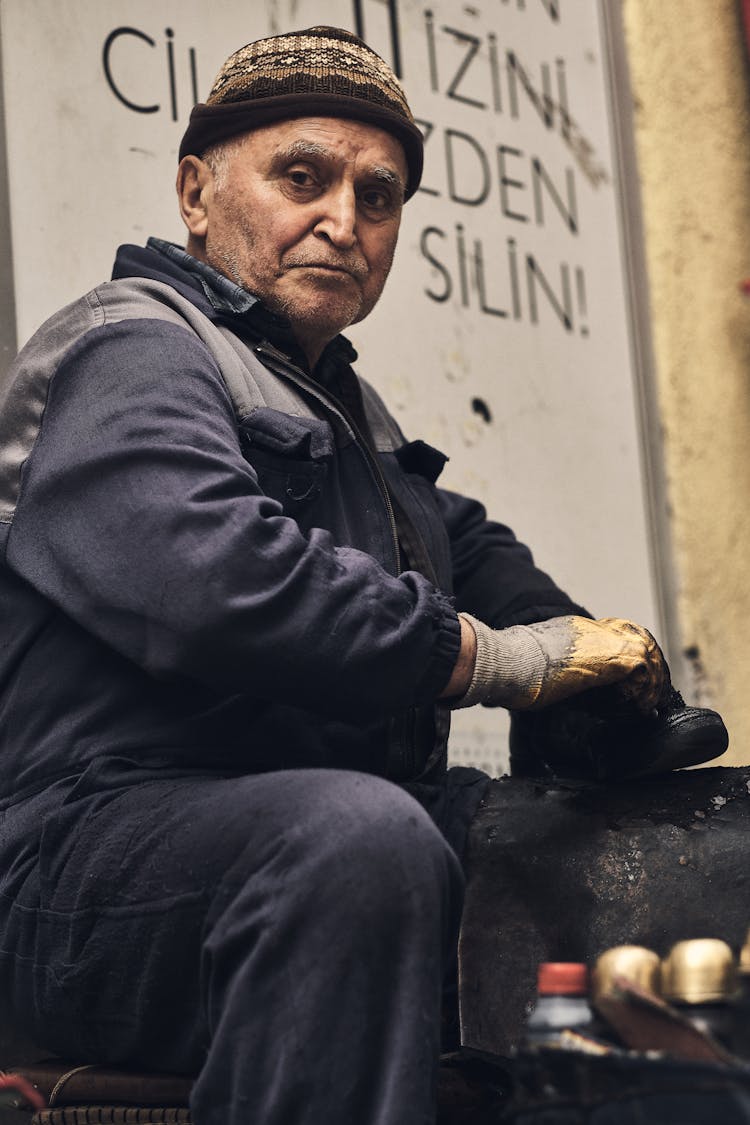 A Man Cleaning A Shoe On The Street